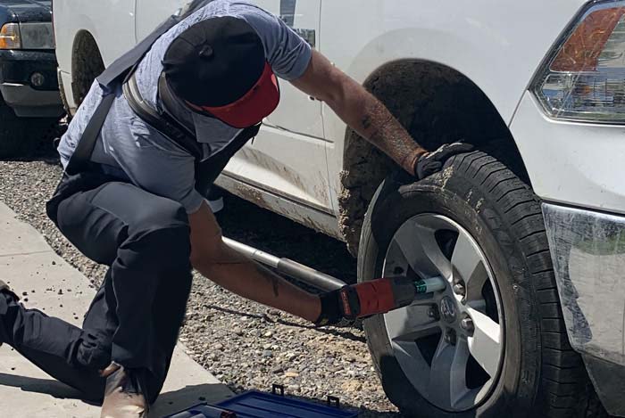 roadside assistance man changing flat tire